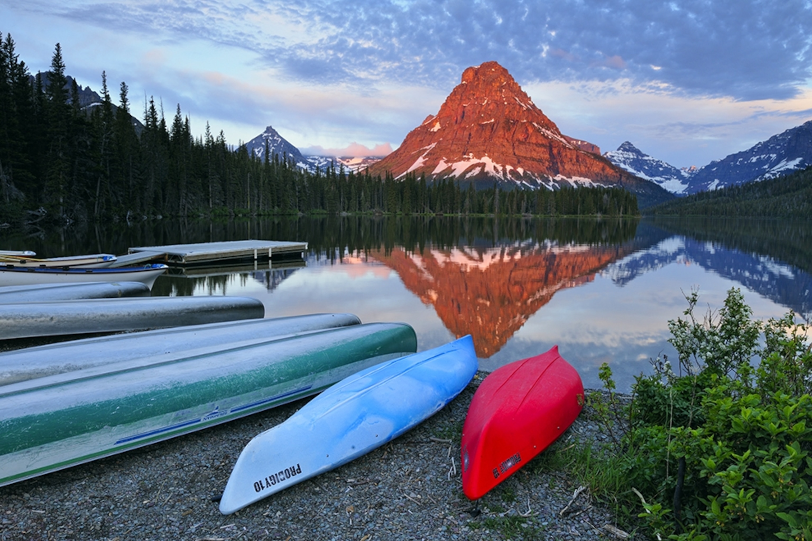 Montana mountain lake with red canoe